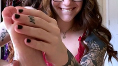 Sexy leggy brunette enjoys foot fetish