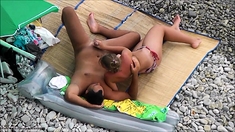 Huge cumshot as milf gives incredible beach handjob