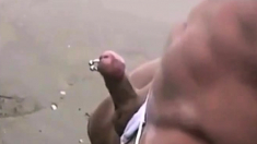 Asian bodybuilder barely covered at the beach